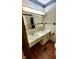 Bathroom with double vanity and laminate flooring, equipped with functional fixtures at 3702 Candy Cane Dr, Indianapolis, IN 46227
