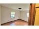 A sunlit bedroom showcases two windows, neutral walls, modern flooring, and a unique ceiling fixture at 3702 Candy Cane Dr, Indianapolis, IN 46227