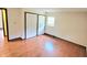 Bright bedroom featuring wood floors, a window, and a double-door closet for ample storage at 3702 Candy Cane Dr, Indianapolis, IN 46227