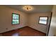 This bedroom has windows that offers natural light and hardwood flooring at 3702 Candy Cane Dr, Indianapolis, IN 46227