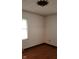 Cozy bedroom featuring neutral walls, laminate flooring, and an ornate light fixture at 3702 Candy Cane Dr, Indianapolis, IN 46227