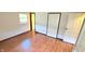 A simple bedroom featuring wood floors, a small window, and a double-door closet at 3702 Candy Cane Dr, Indianapolis, IN 46227