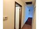 Inviting hallway with neutral walls, showcasing the transition between carpet and vinyl flooring at 3702 Candy Cane Dr, Indianapolis, IN 46227