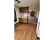 Bright kitchen featuring wood cabinets and breakfast bar, opening to living room with fireplace at 3702 Candy Cane Dr, Indianapolis, IN 46227