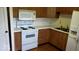 Functional kitchen features wood cabinets, white appliances, and laminate countertops at 3702 Candy Cane Dr, Indianapolis, IN 46227