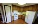 Efficient kitchen with white appliances, wood cabinets, and laminate countertops at 3702 Candy Cane Dr, Indianapolis, IN 46227