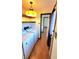 Bright laundry room featuring modern washer, dryer, yellow lighting fixture, and open shelving for storage solutions at 3702 Candy Cane Dr, Indianapolis, IN 46227