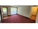 A spacious living room with carpet, a front door, and a window to the outside at 3702 Candy Cane Dr, Indianapolis, IN 46227