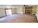 Spacious living room with a brick fireplace, built-in shelving, and sliding glass doors to the outside at 3702 Candy Cane Dr, Indianapolis, IN 46227