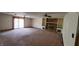 Spacious living room with fireplace, built-in shelving, and a sliding glass door at 3702 Candy Cane Dr, Indianapolis, IN 46227
