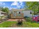 Delightful backyard with a wooden deck, patio, a fire pit, and greenery; a perfect space for relaxation and gatherings at 376 S Arlington Ave, Indianapolis, IN 46219