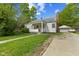 Charming single-story home with a covered front porch, lovely landscaping, and a detached garage at 376 S Arlington Ave, Indianapolis, IN 46219