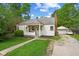 Charming single-story home with a covered front porch, lovely landscaping, and a detached garage at 376 S Arlington Ave, Indianapolis, IN 46219