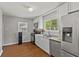 Bright kitchen features stainless steel appliances, white cabinetry, and a large window for natural light at 376 S Arlington Ave, Indianapolis, IN 46219