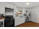 Modern kitchen featuring stainless steel appliances, gas range, white cabinets, and subway tile backsplash at 376 S Arlington Ave, Indianapolis, IN 46219