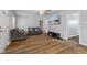 Cozy living room with wood floors, gray sofas, and a wall-mounted television at 376 S Arlington Ave, Indianapolis, IN 46219