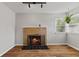 Living room showcasing a brick fireplace with a black tile hearth and a bright window at 376 S Arlington Ave, Indianapolis, IN 46219