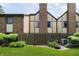 A quaint back yard is landscaped with small shrubs, flowers, and grassy area that is fenced in at 3852 Knollton Rd # 3852, Indianapolis, IN 46228
