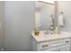 Bathroom featuring a large mirror, a vanity sink, and fresh white cabinets at 3852 Knollton Rd # 3852, Indianapolis, IN 46228