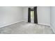 A bright bedroom with a window dressed with dark draperies showing the neutral paint and plush carpeting at 3852 Knollton Rd # 3852, Indianapolis, IN 46228
