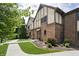 Attractive townhome with brick accents, manicured lawn, and charming exterior features at 3852 Knollton Rd # 3852, Indianapolis, IN 46228