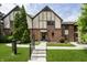 Charming townhome with brick facade, peaked roofline and well-manicured lawn and garden at front entrance at 3852 Knollton Rd # 3852, Indianapolis, IN 46228