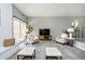 Bright living room boasts neutral colors, carpet, and a large window for plenty of natural light at 3852 Knollton Rd # 3852, Indianapolis, IN 46228