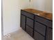 Close-up of dark vanity with drawers and doors sitting on the bathroom floor at 3897 Berkdale Ct, Columbus, IN 47203