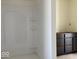 A white shower in a bathroom, with a vanity that has dark drawers and doors at 3897 Berkdale Ct, Columbus, IN 47203