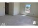 Bright bedroom featuring a window and a doorway, awaiting a personalized touch at 3897 Berkdale Ct, Columbus, IN 47203