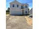 Two-story new construction home featuring an attached two-car garage on a sunny day at 3897 Berkdale Ct, Columbus, IN 47203