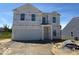 New two-story home featuring an attached two-car garage and classic architectural details at 3897 Berkdale Ct, Columbus, IN 47203