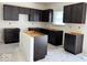 Unfinished kitchen with dark wood cabinetry, providing a customizable space for cooking and dining at 3897 Berkdale Ct, Columbus, IN 47203