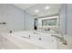 Spacious bathroom features a jetted tub with tile surround and a large mirror at 410 Sugar Tree Ln, Indianapolis, IN 46260