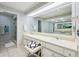 Bright bathroom showcasing double vanity, well-lit mirrors, and a glass door shower at 410 Sugar Tree Ln, Indianapolis, IN 46260