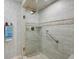 Updated shower features neutral tile and a built-in grab bar for safety and accessibility at 410 Sugar Tree Ln, Indianapolis, IN 46260