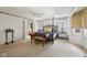 Large bedroom features a seating bench, neutral walls, and an ensuite bathroom entrance at 410 Sugar Tree Ln, Indianapolis, IN 46260