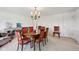 Dining room featuring a round table with seating for six and classic chandelier at 410 Sugar Tree Ln, Indianapolis, IN 46260