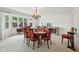 Formal dining room featuring a large window, classic chandelier, and seating for six at 410 Sugar Tree Ln, Indianapolis, IN 46260