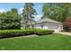Lovely single-story home featuring lush green lawn and manicured landscaping at 410 Sugar Tree Ln, Indianapolis, IN 46260
