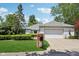 Charming single-story home with manicured lawn, brick mailbox, and attached two-car garage at 410 Sugar Tree Ln, Indianapolis, IN 46260