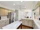 Spacious kitchen featuring white cabinets, stainless steel refrigerator, and hardwood floors at 410 Sugar Tree Ln, Indianapolis, IN 46260