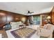 Generous office with beautiful dark wood paneled walls and built-in book cases and cabinetry at 410 Sugar Tree Ln, Indianapolis, IN 46260