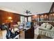 Spacious office area featuring wood paneling, built in shelving and plenty of natural light at 410 Sugar Tree Ln, Indianapolis, IN 46260