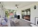 Cozy sunroom with ceiling fan, comfortable sofa, and sliding doors to the backyard at 410 Sugar Tree Ln, Indianapolis, IN 46260