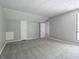 Bright bedroom featuring neutral carpet, multiple doors, and a large window for natural light at 4268 Foxglove Trce, Indianapolis, IN 46237