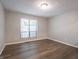 Neutral bedroom featuring wood-look flooring and a bright window at 4268 Foxglove Trce, Indianapolis, IN 46237