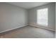 This bedroom features gray walls, carpet, and a window with blinds at 4268 Foxglove Trce, Indianapolis, IN 46237
