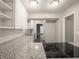 Well-lit kitchen with white cabinets, granite countertops, and open view to the living area at 4268 Foxglove Trce, Indianapolis, IN 46237