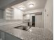 Bright kitchen featuring granite countertops, white cabinets, and stainless steel appliances at 4268 Foxglove Trce, Indianapolis, IN 46237
